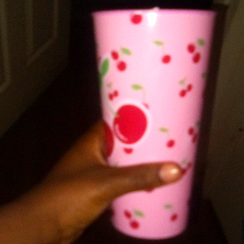 A CHERRY CUP WITH STRAW